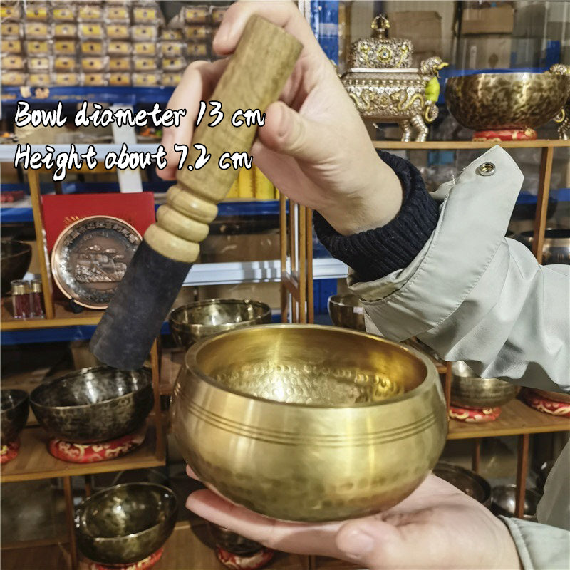 Tibetan brass singing bowl with Sanskrit – handmade meditation instrument for stress relief.